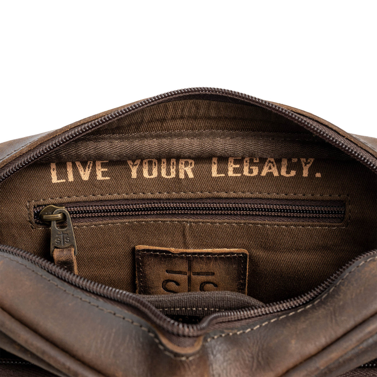 STS Ranchwear cowhide Jess crossbody bag with adjustable strap and detailed leather stitching, shown in natural cowhide finish.