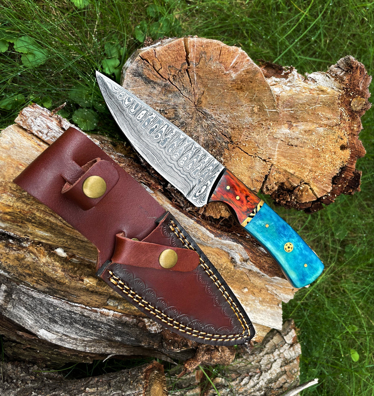Titan International K Damascus hunting knife with Garnet Starlight hand-forged blade, designed for outdoor and hunting use.