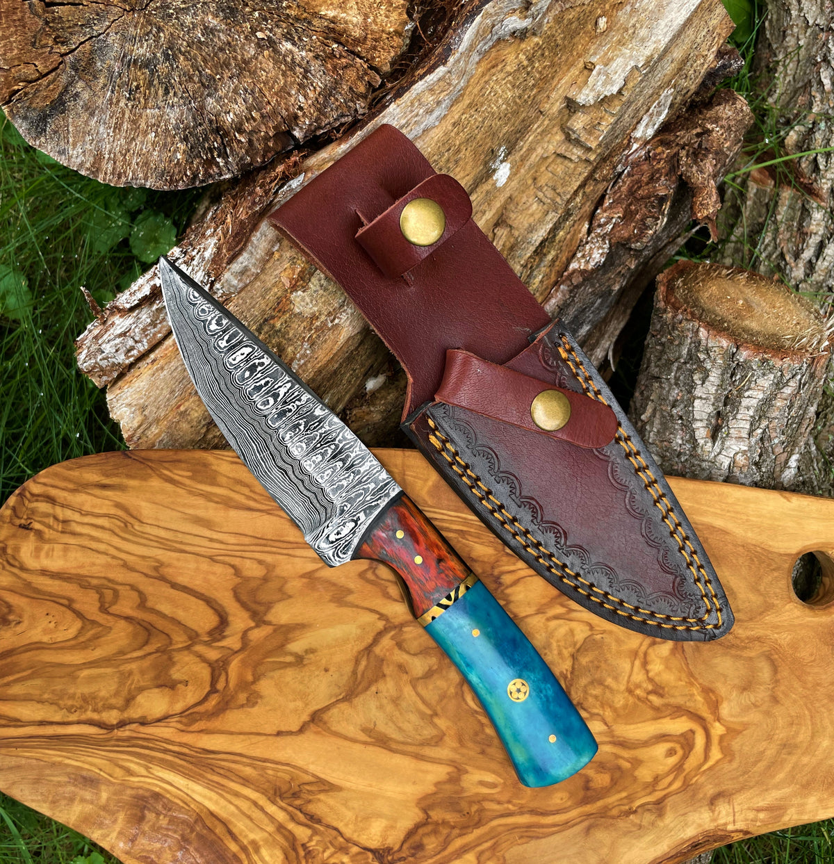 Damascus garnet Starlight hunting knife by Titan International K, hand-forged blade with intricate pattern, ideal for outdoor use.