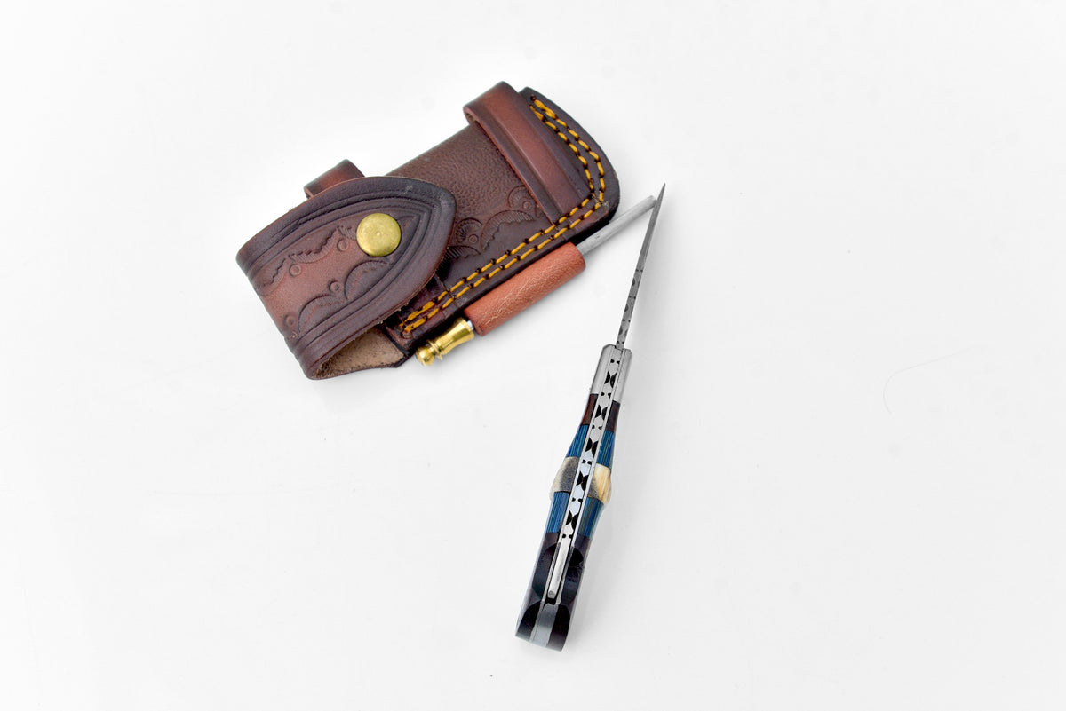 Damascus steel pocket knife by Titan International K with a patterned blade and ergonomic handle, limited run TF-071.