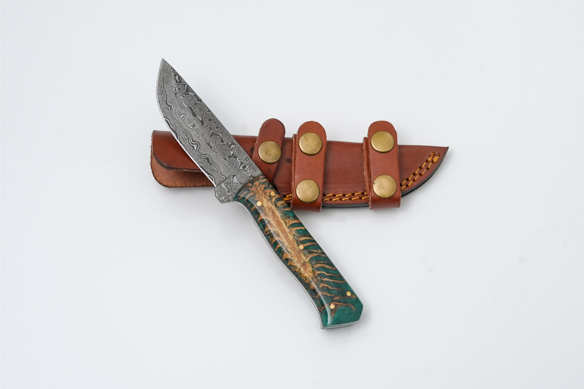 Damascus Steel Titan Gecko fixed blade knife with forest green pine cone resin handle and detailed steel blade.