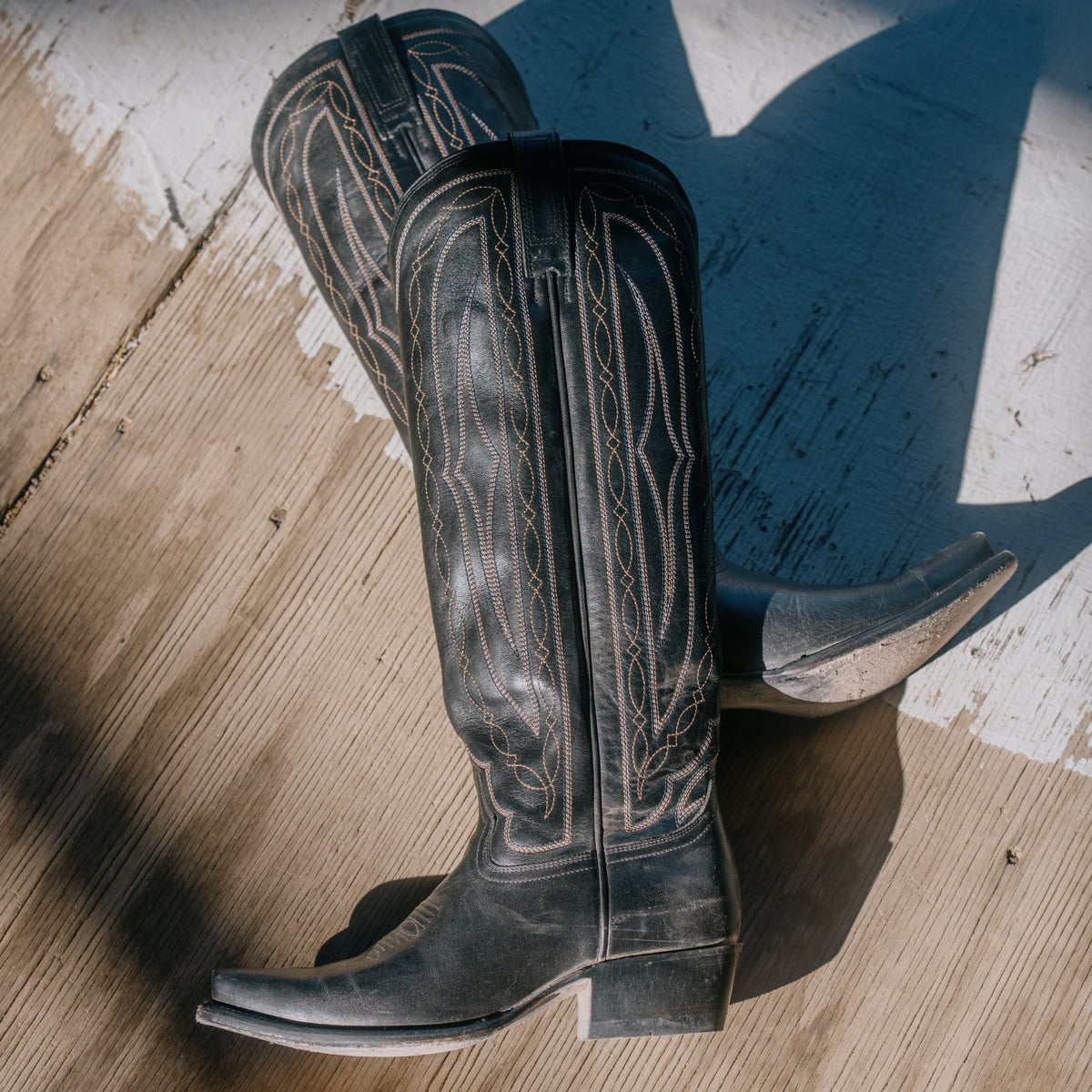 HYER Women's Wildcat Tall Black Boot showing sleek black leather upper and tall boot silhouette with pointed toe and block heel.
