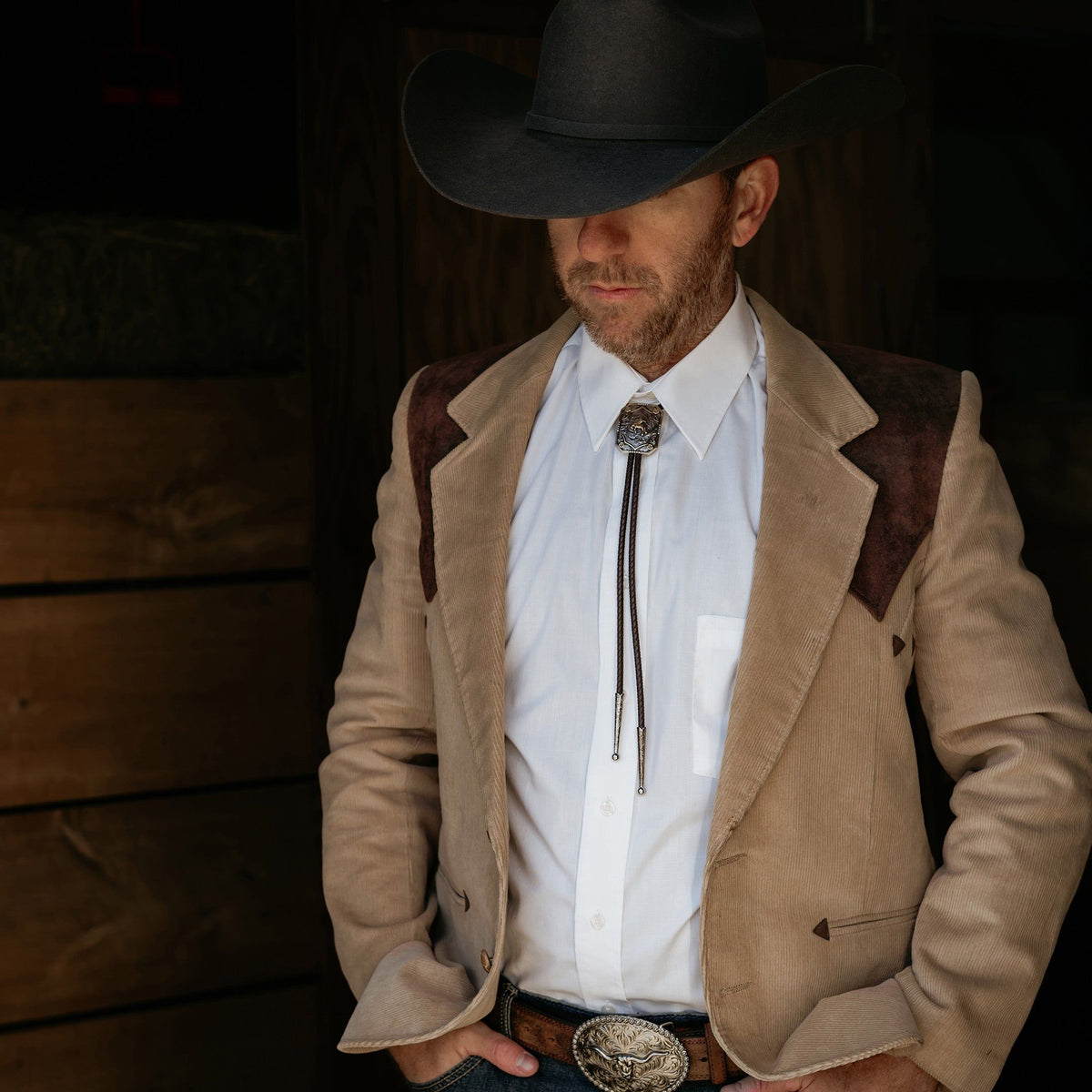 AndWest Iconic Bronc Rider Bolo Tie featuring a detailed Western-themed bronze rider design on a leather cord.