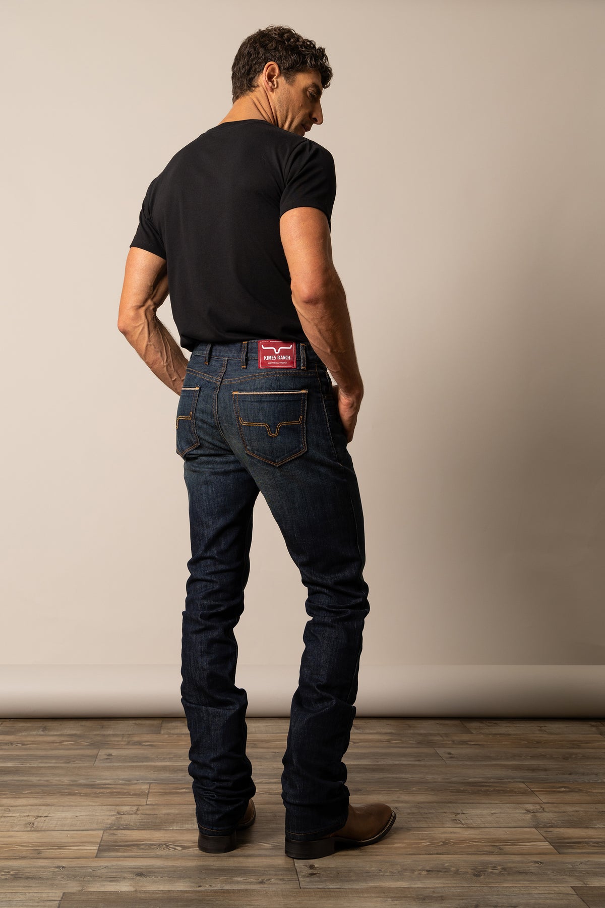 Kimes Ranch Men's Roger Jean in dark wash denim, slim fit style with classic five-pocket design and leather logo patch.