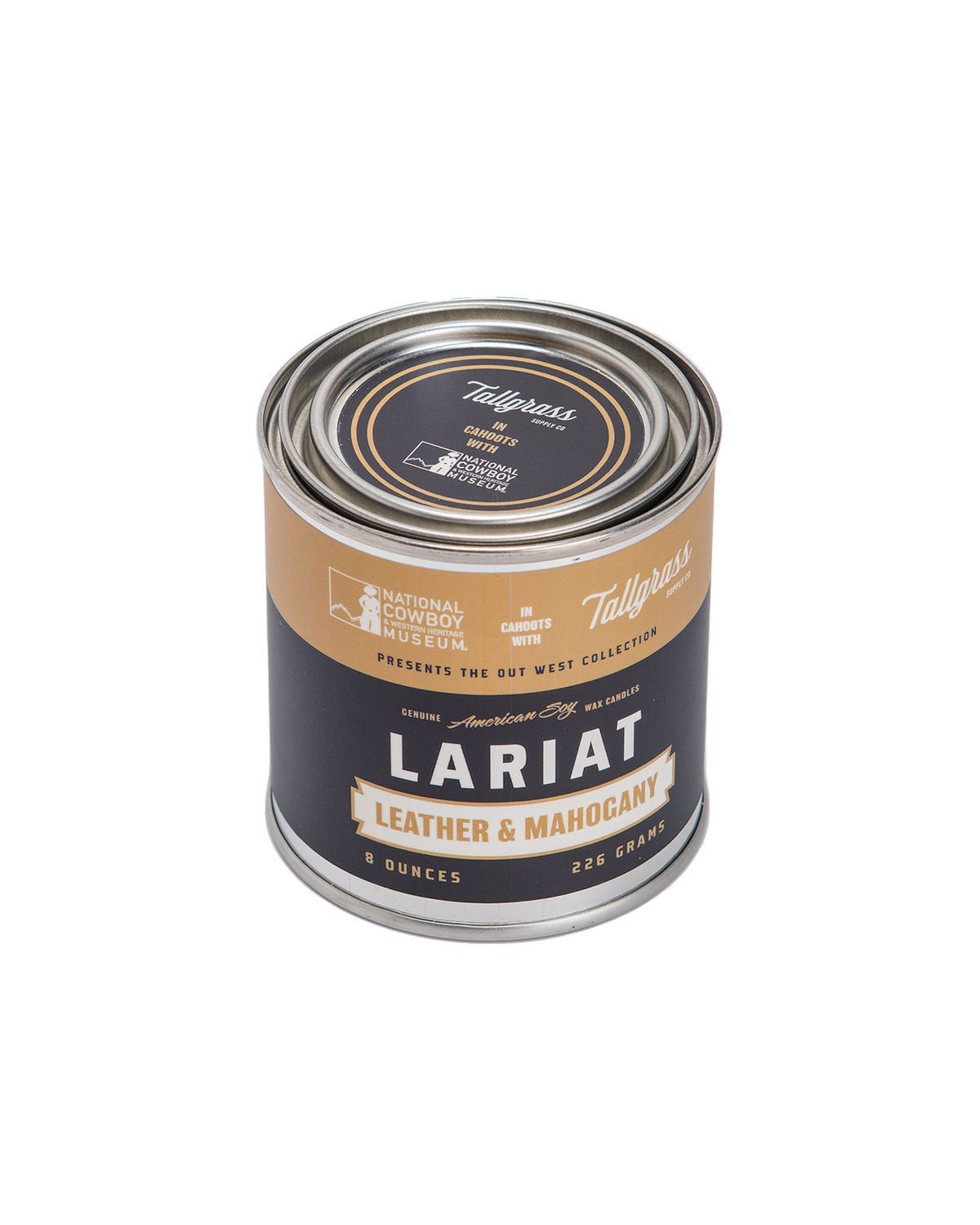 Tallgrass Supply leather and mahogany soy wax candle with a lariat-style leather accent, displayed in a natural setting