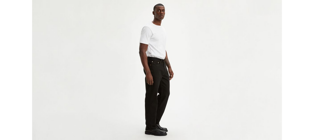Black Levi's 550™ relaxed fit men's jeans, shown hanging on a rack with visible stitching and classic five-pocket design.