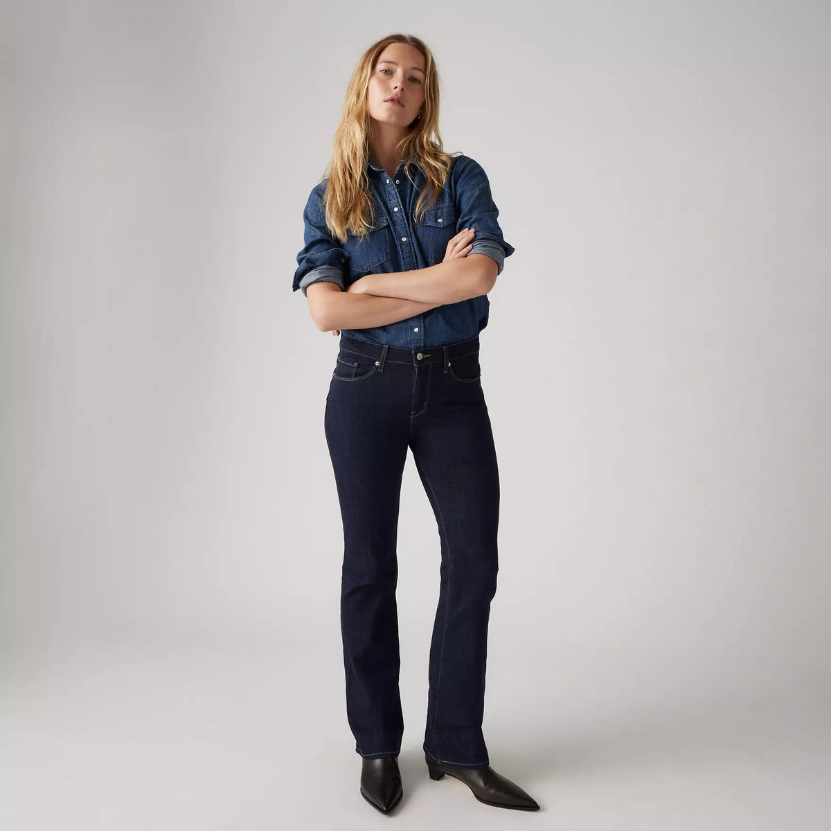 Levi's Women's Classic Bootcut Jeans in dark wash, with a fitted waistband and flared leg style, displayed on a model.