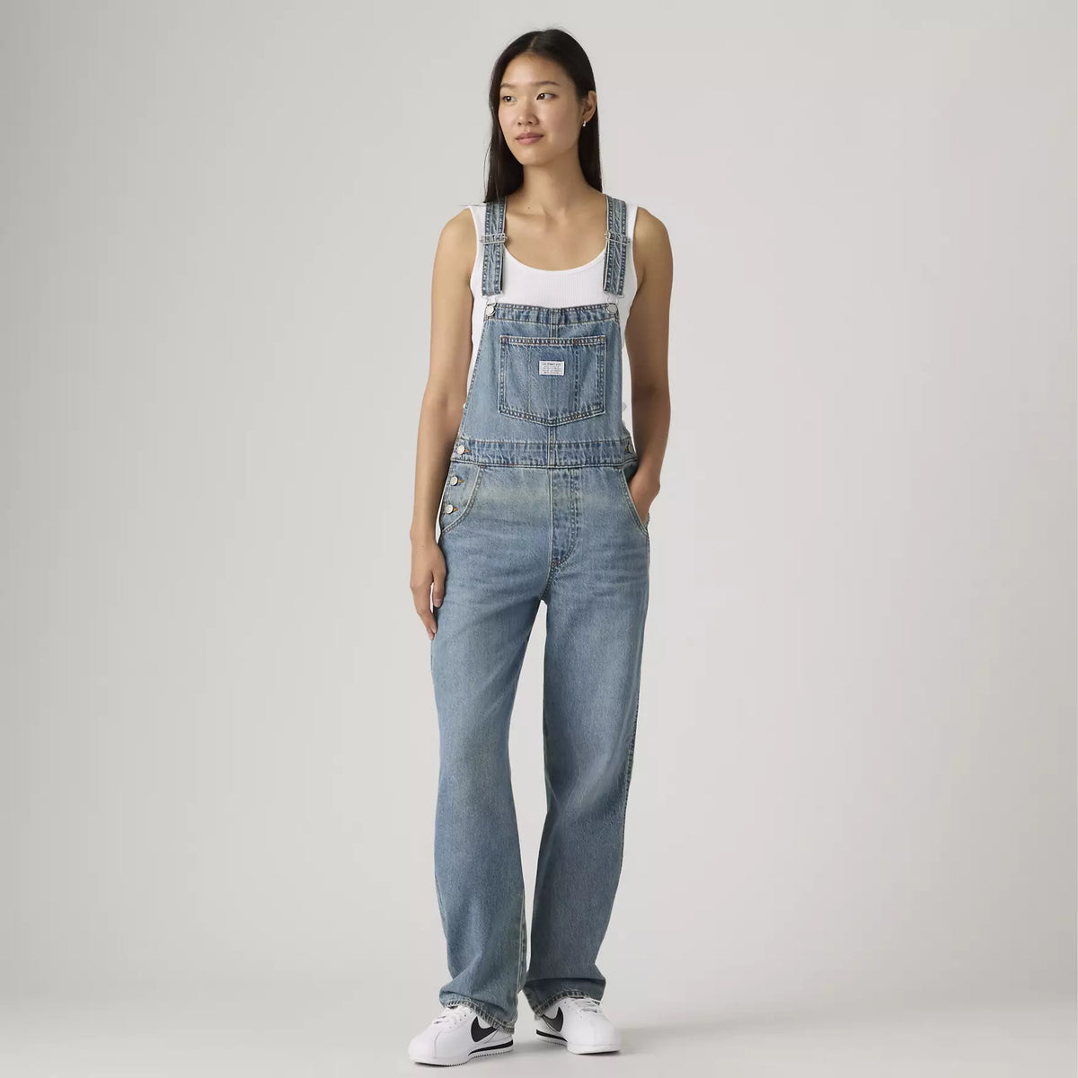 Levi's women's vintage denim overalls in medium wash with adjustable straps and front pockets, casual and stylish for everyday wear.