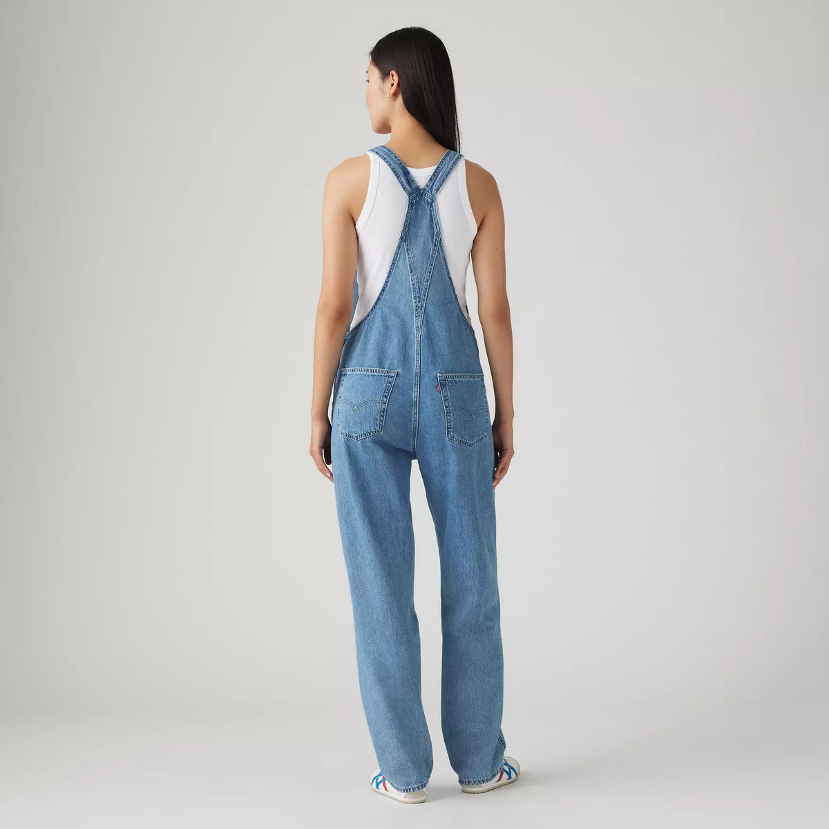 Levi's women's vintage denim overalls in medium wash, featuring adjustable straps and front pockets, casual and stylish.