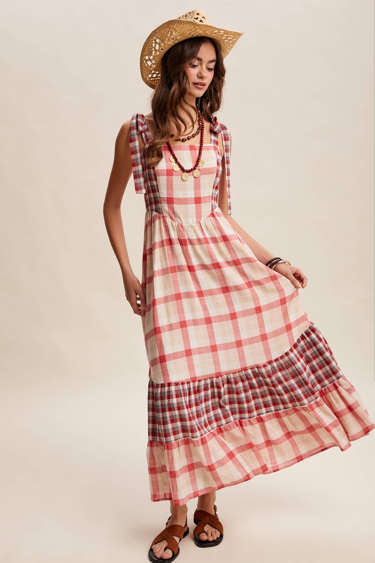 Gingham tiered maxi dress by Listicle featuring a flowy, layered design and adjustable straps in a classic checkered pattern.