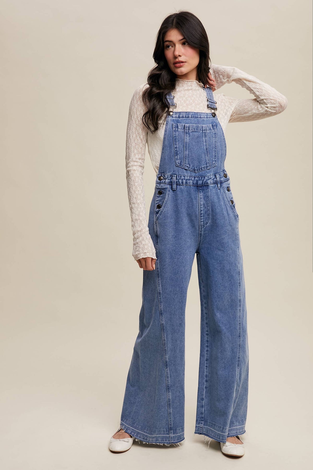 Wide-leg denim overalls by Listicle featuring adjustable straps, front pockets, and a relaxed fit in classic blue denim.