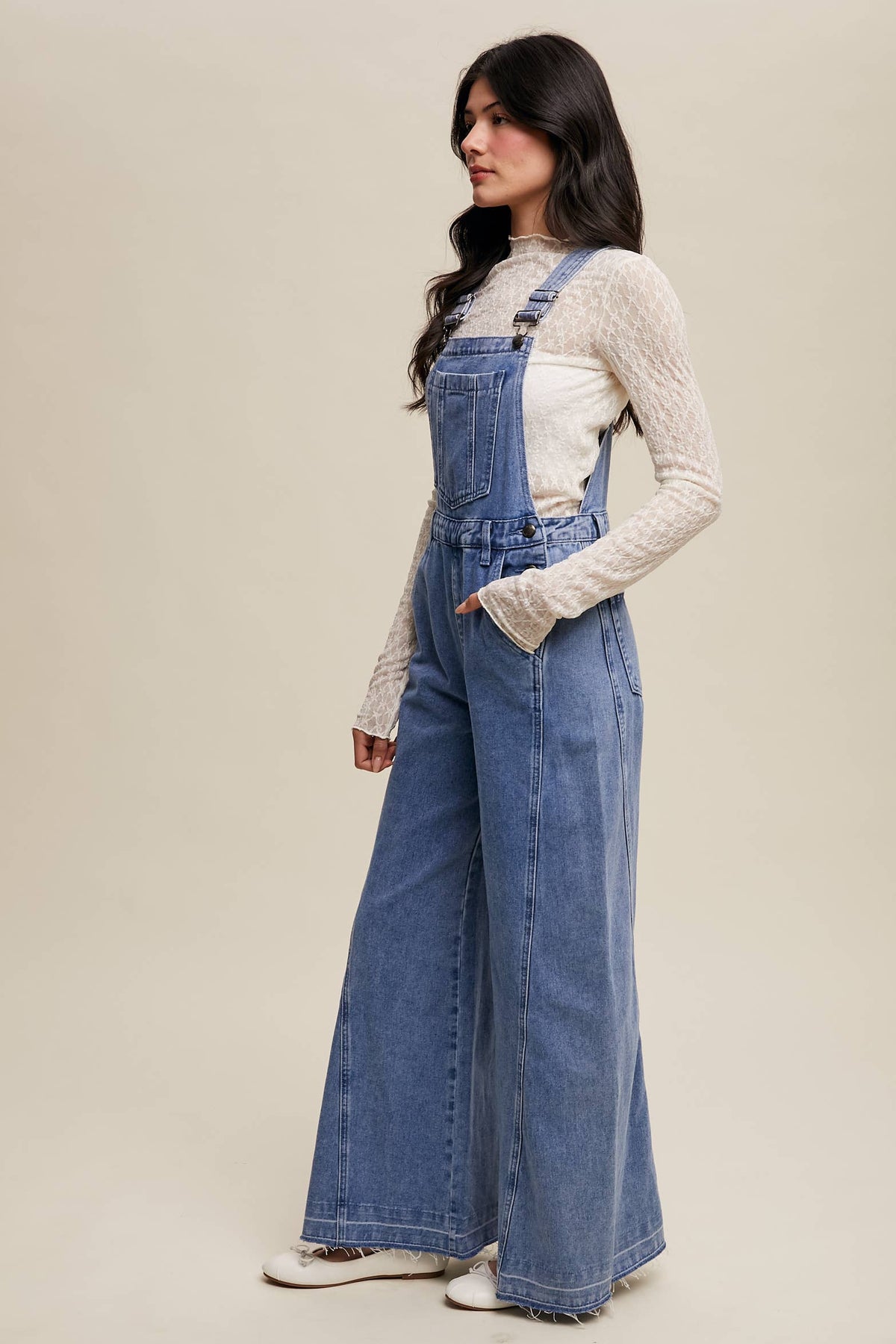 Wide-leg denim overalls by Listicle featuring a relaxed fit and classic blue denim fabric, shown on a model.