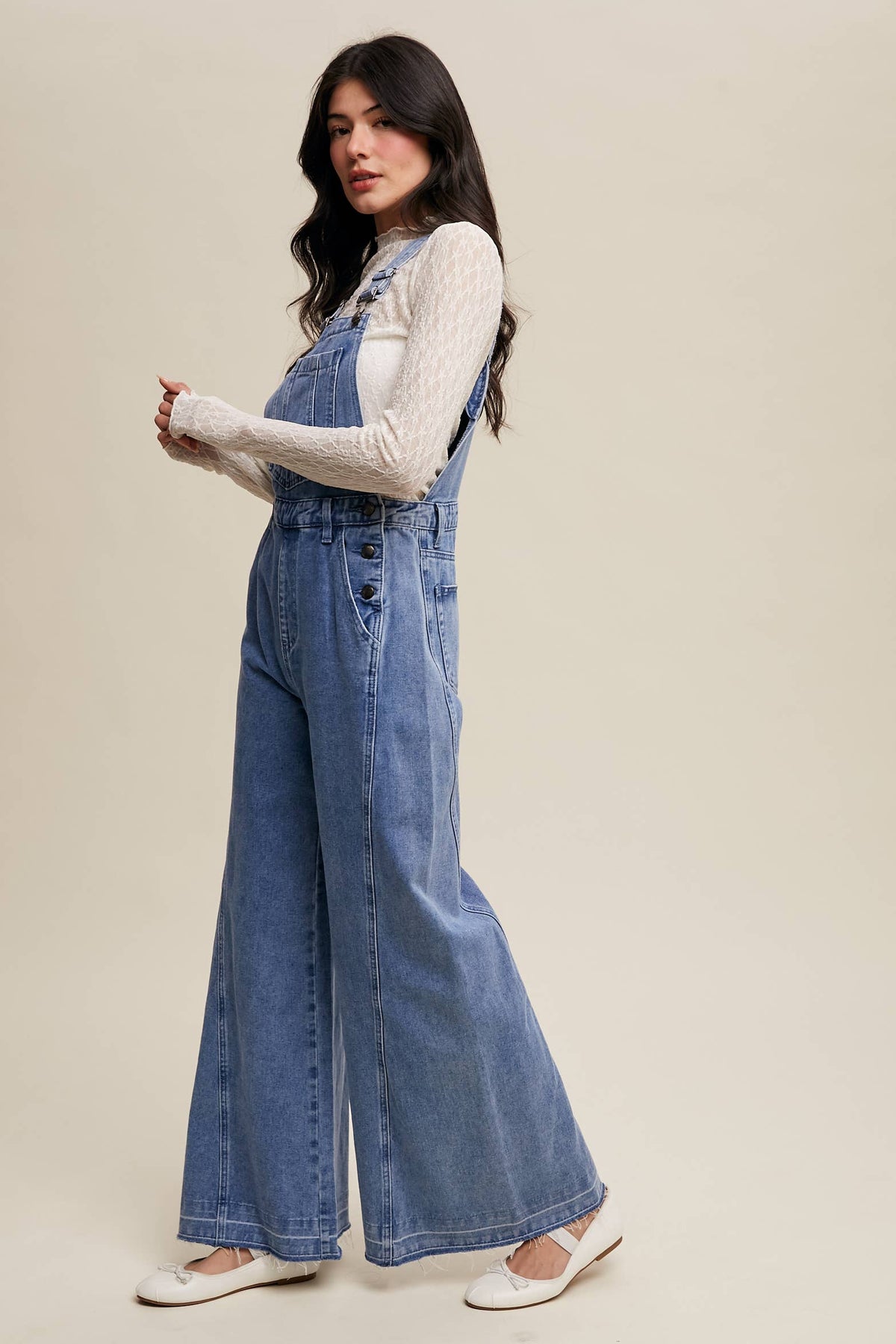 Wide-leg denim overalls by Listicle featuring adjustable straps, front pockets, and a relaxed fit, perfect for casual wear.