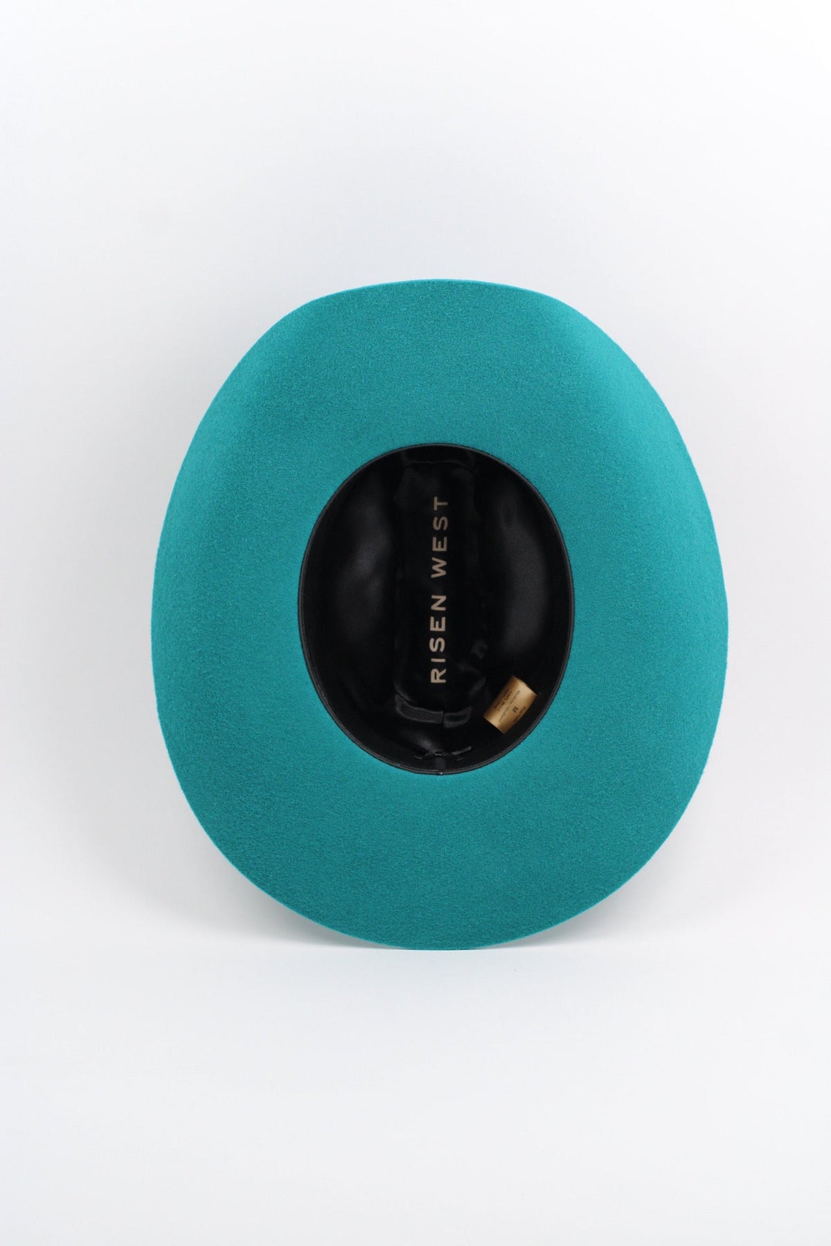 Wilder and Soul Mustang in turquoise, showcasing its vibrant color and detailed design on a sleek, stylish product.