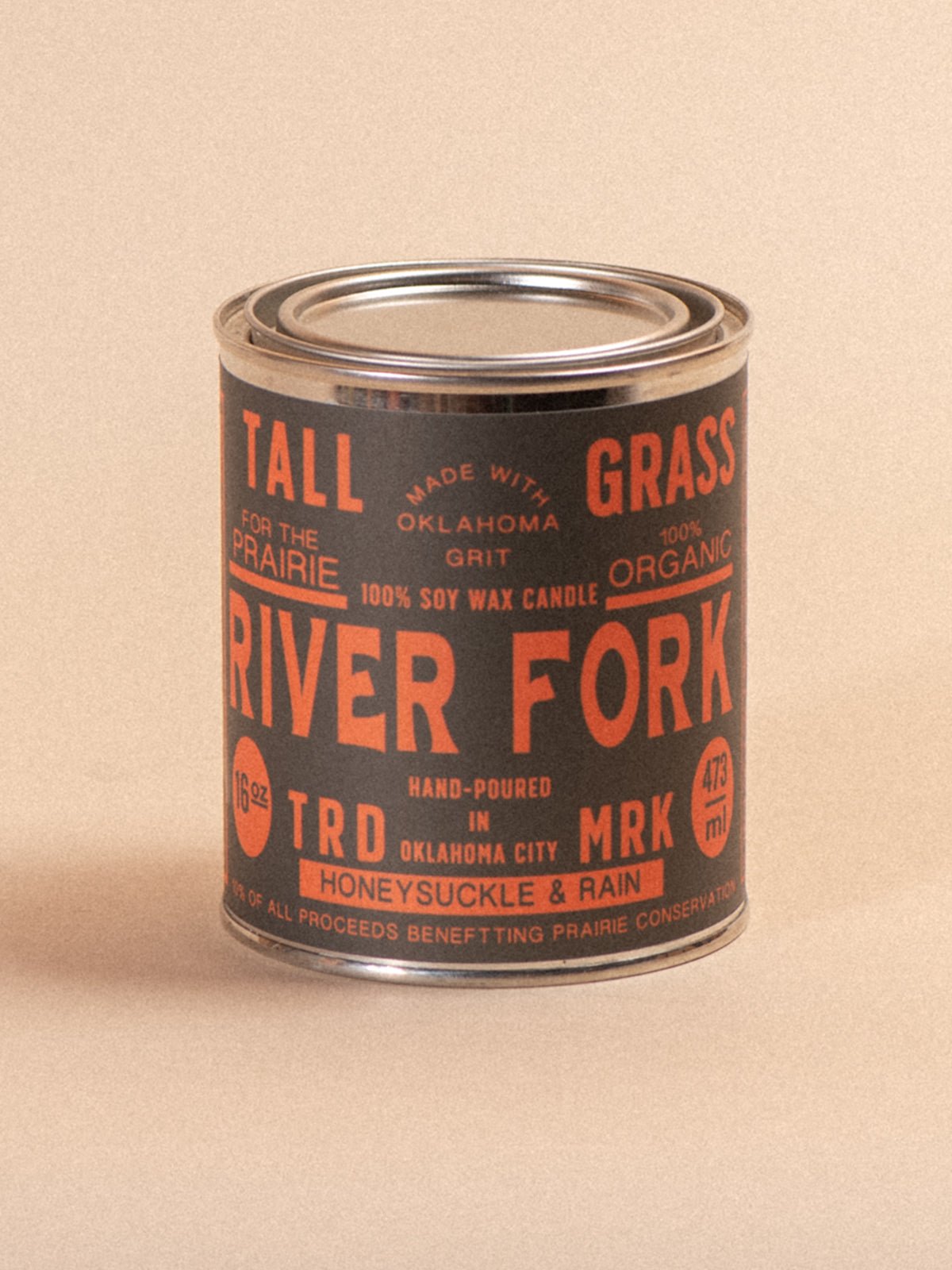Tallgrass Supply River Fork Honeysuckle and Rain soy wax candle in a glass jar with a wooden lid, candles burning softly.