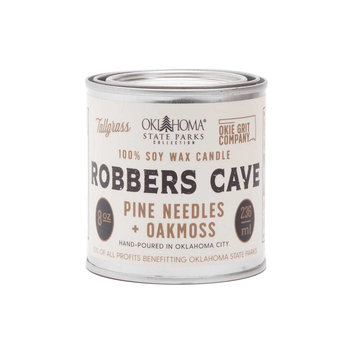 Tallgrass Supply Robbers Cave soy wax candle with pine needles and oakmoss scent, featuring a tall, elegant candle in a clear glass jar.