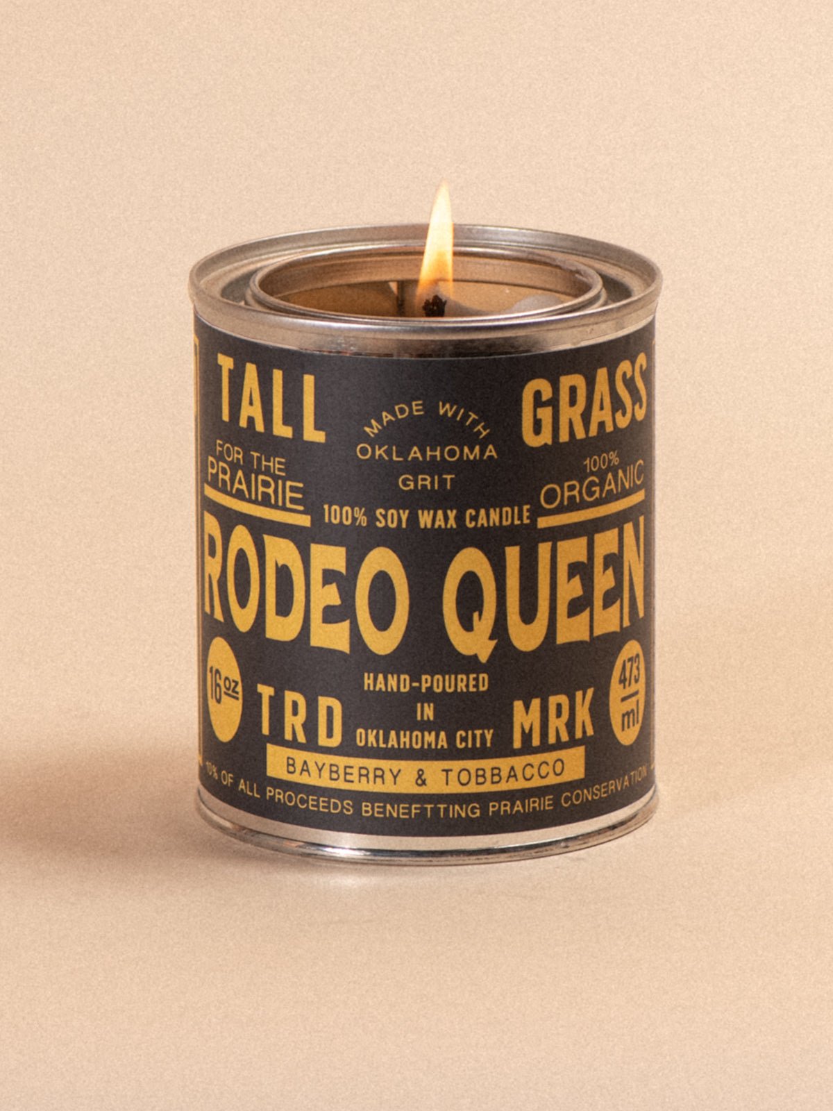 Tallgrass Supply Rodeo Queen soy wax candle with bayberry and tobacco scent, showcasing a tall, elegant candle in a natural setting.
