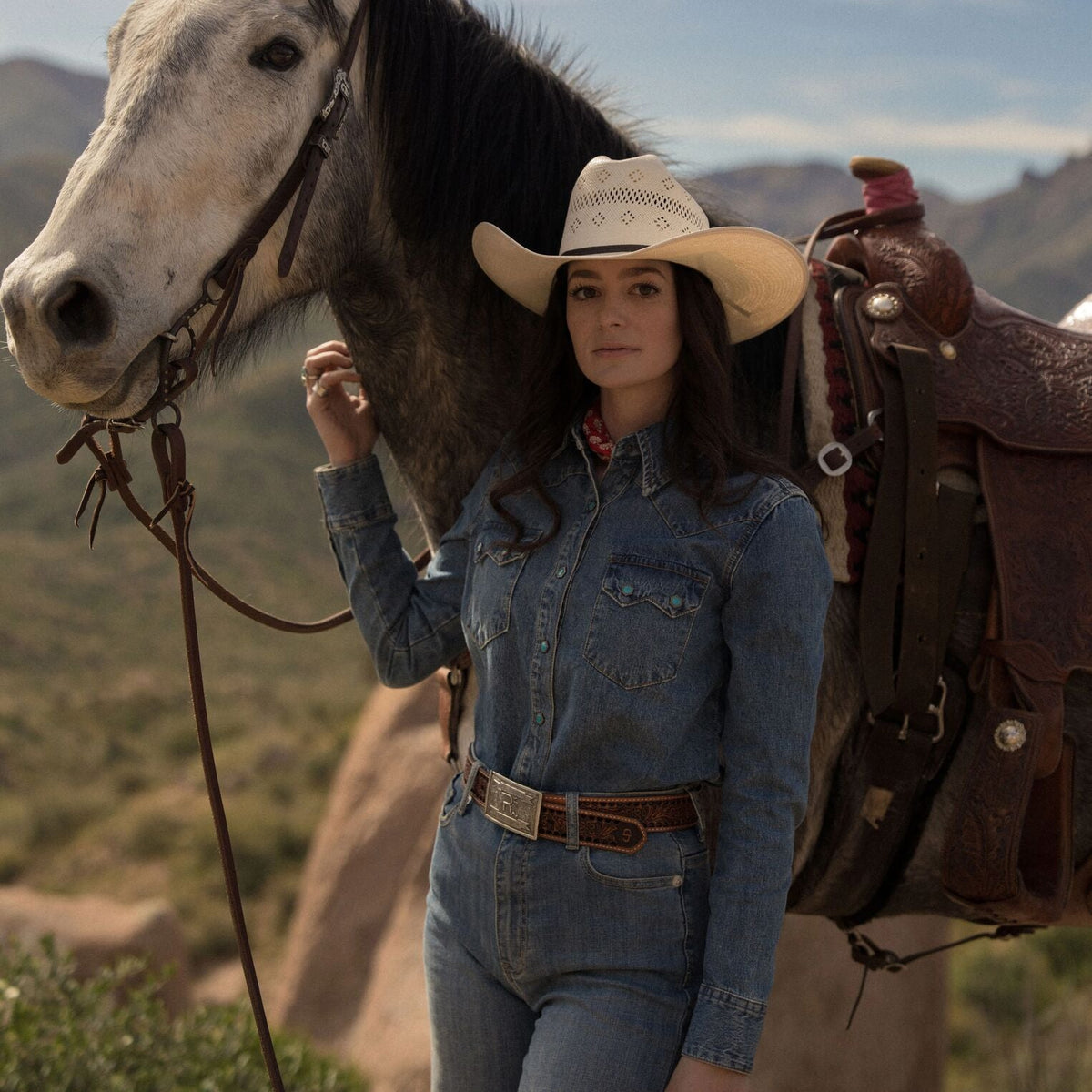 Stetson turquoise snap western denim shirt with button-down front and classic Western styling, displayed on a hanger.