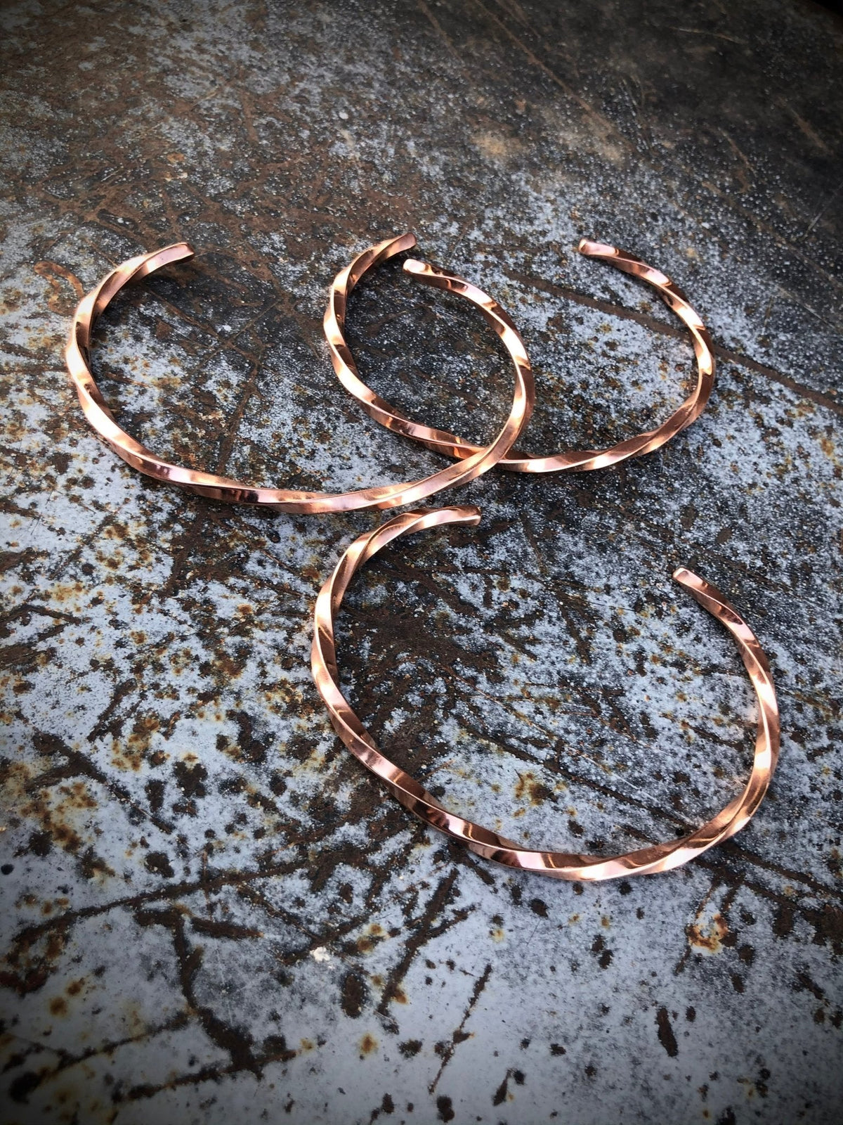 Handmade unisex twisted silver cuff bracelet by Boles Silver, showcasing a sleek, textured jewelry design.