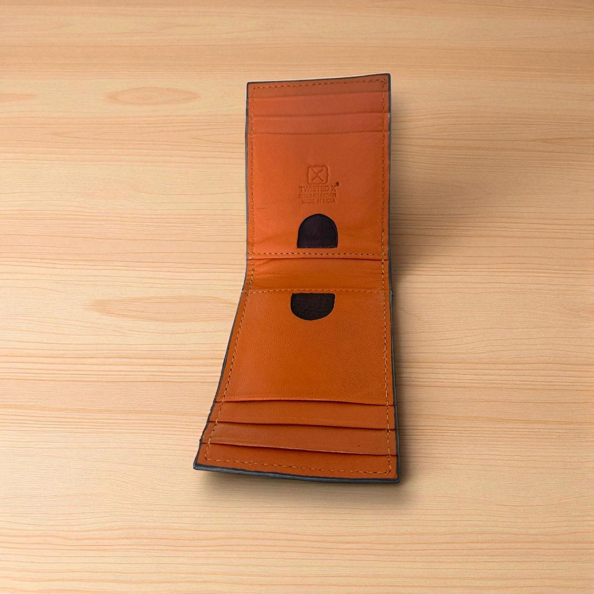 Twisted X leather money clip card holder opened, showing the interior card pockets