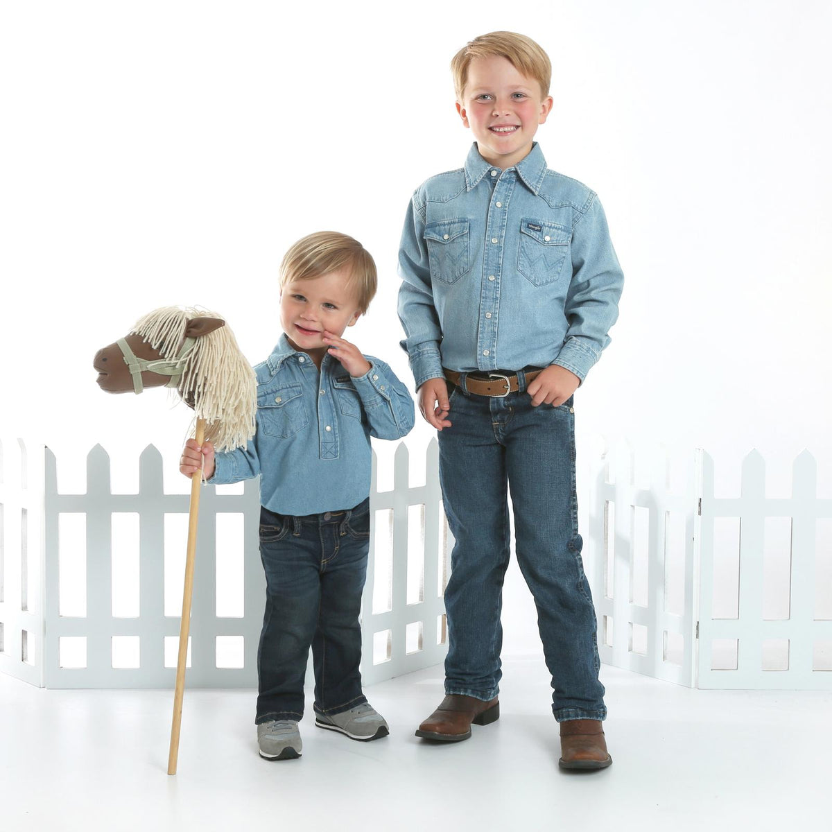 Wrangler Kids' navy stonewashed denim long sleeve snap shirt with solid design, suitable for boys or girls.