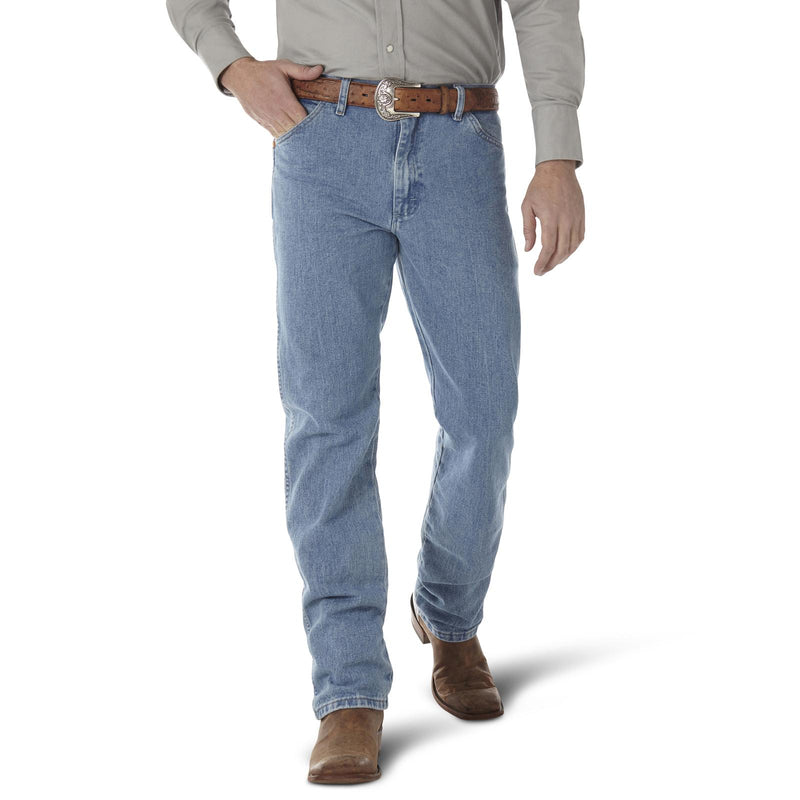 Wrangler Men's Cowboy Cut Original Fit jeans in prewashed indigo denim, shown with a classic antique wash finish.