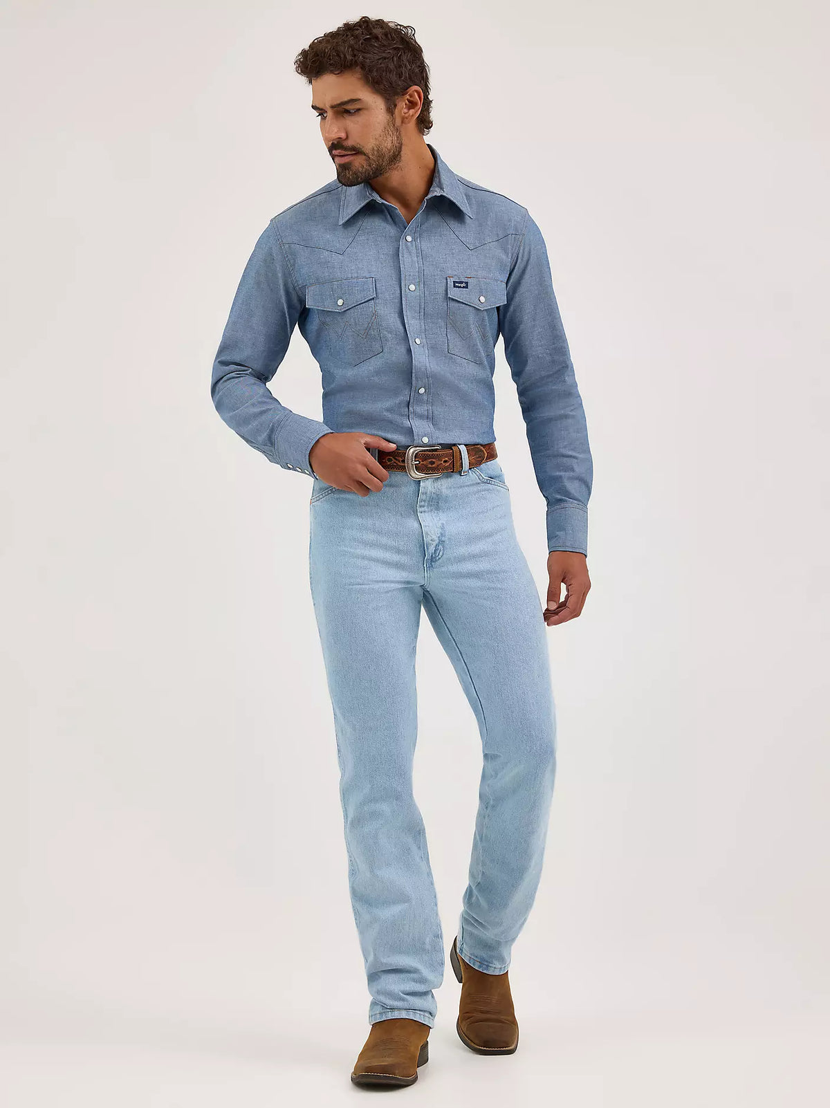 Wrangler Men's Cowboy Cut Slim Fit jeans in bleach wash, featuring classic five-pocket design and durable denim fabric.