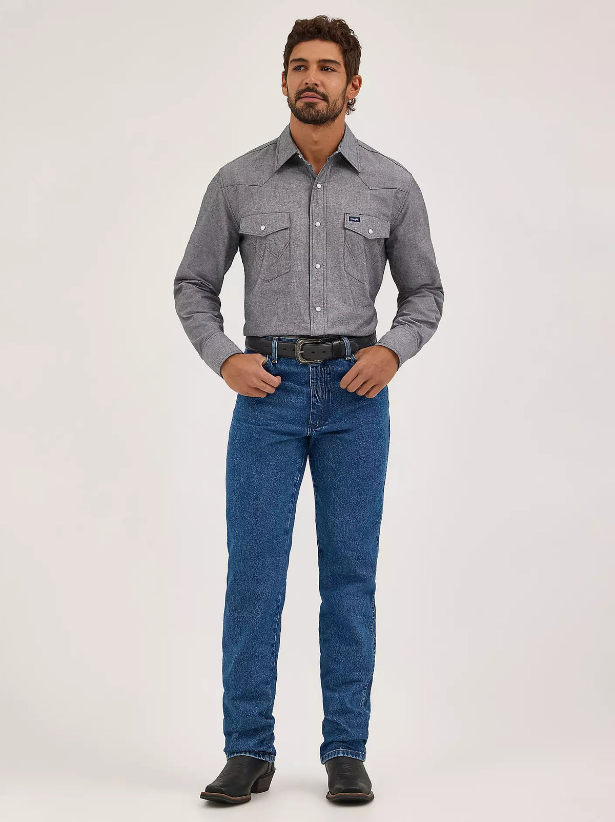 Wrangler Men's Cowboy Cut Slim Fit Stonewashed Jeans displayed on a hanger, showing classic denim with a modern fit.