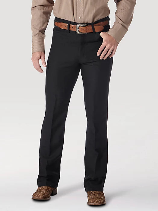 Black Wrangler Wrancher men's dress jeans with classic fit and durable denim fabric, shown hanging on a plain background.